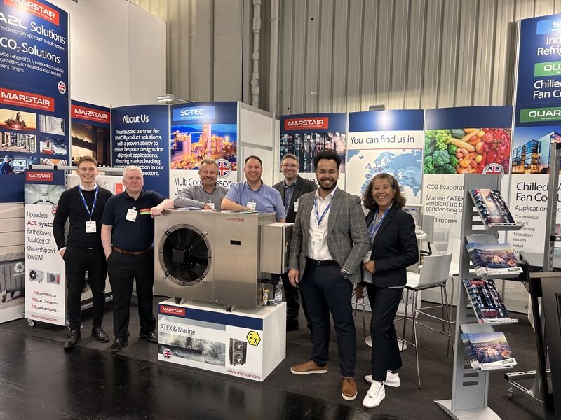 LOCO2S team at an industry exhibition with commercial cooling equipment